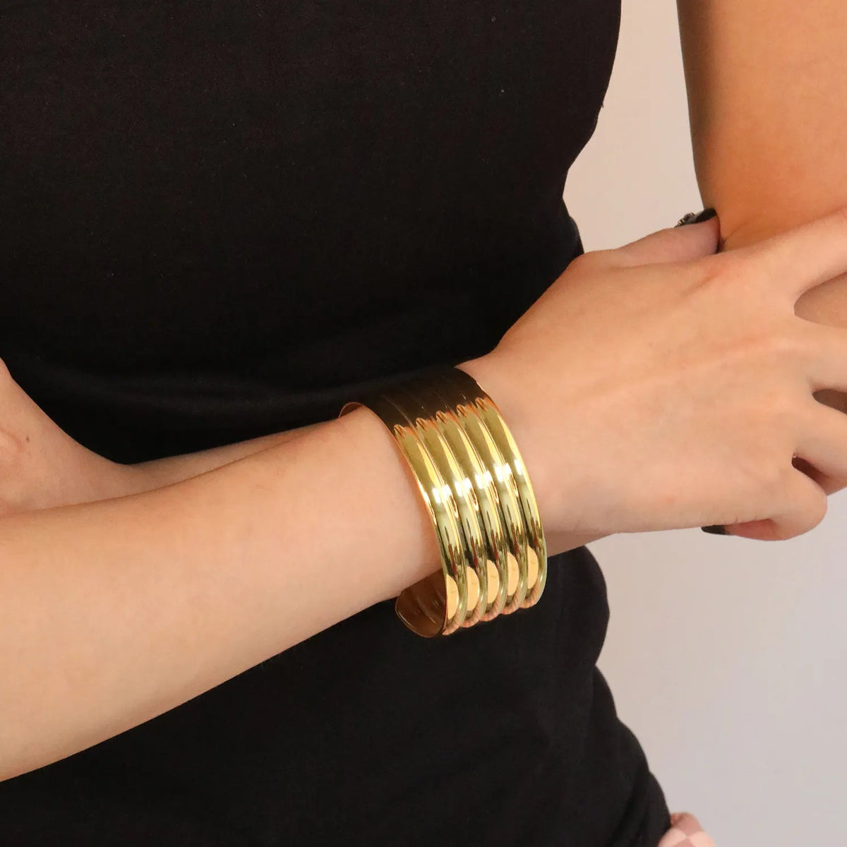 Wide Ribbed Gold Bangle — on model